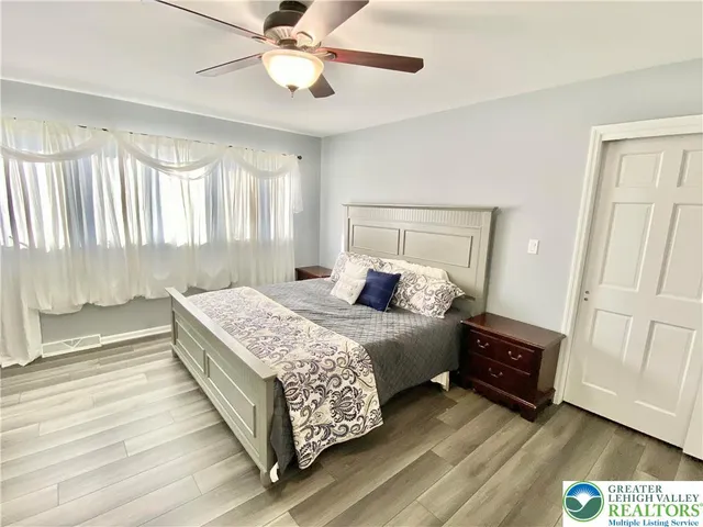 a bedroom with a bed and a chandelier