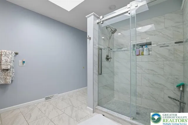 a bathroom with a glass shower door