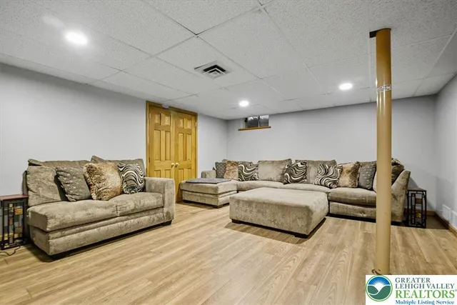 a living room with couches and painted walls