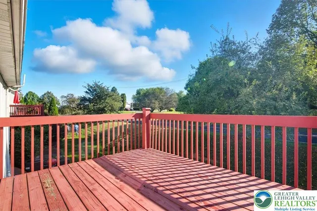 a balcony with wooden floor and fence