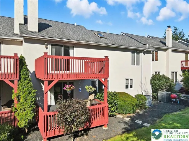 a view of a house with wooden fence