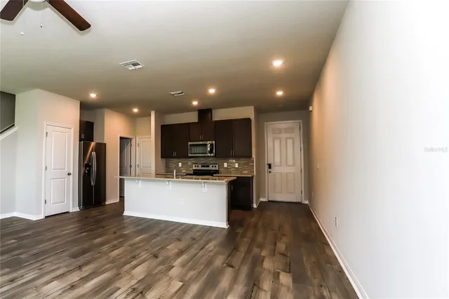a view of kitchen with stainless steel appliances kitchen island a sink dishwasher a refrigerator and a stove