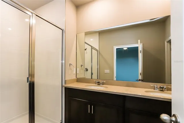 a bathroom with a double vanity sink and a mirror