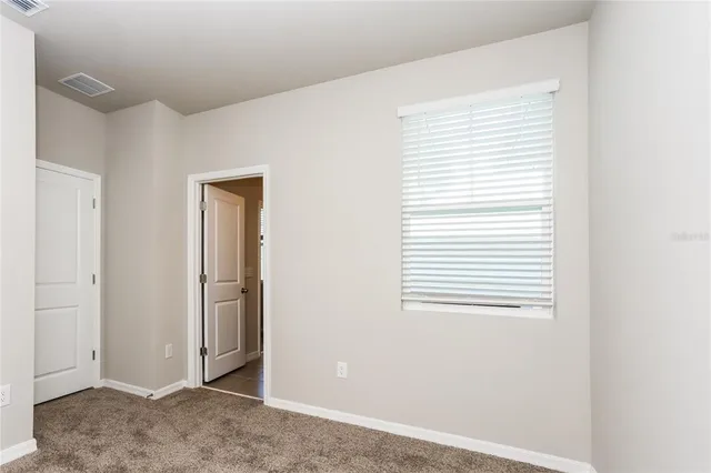 a view of a livingroom with an empty space and a window