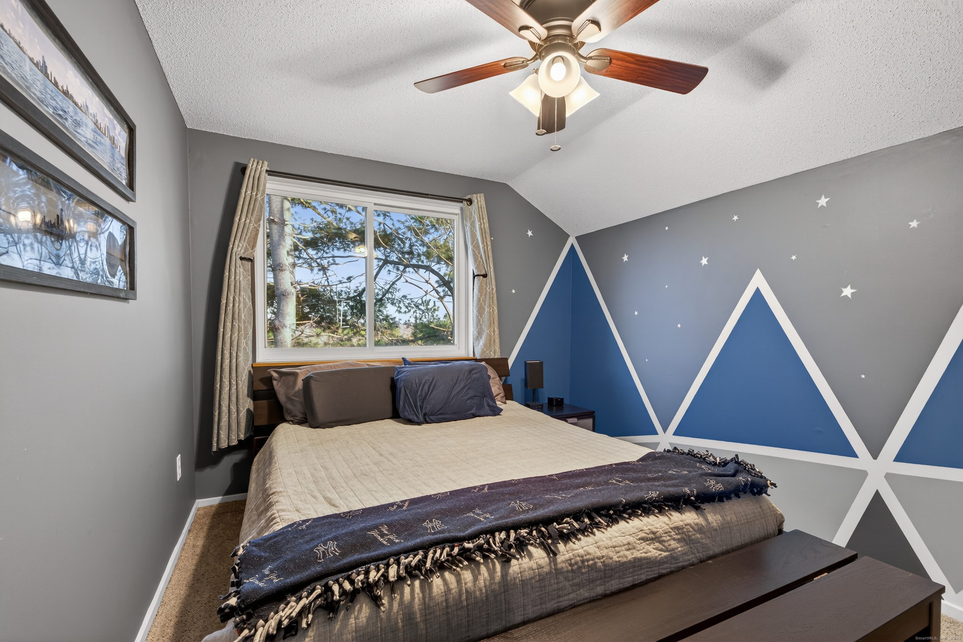 3 Sun Ridge Lane, Unit 3 Cromwell, CT 06416 - Photo 27 of 38 a bedroom with a large bed and a chandelier