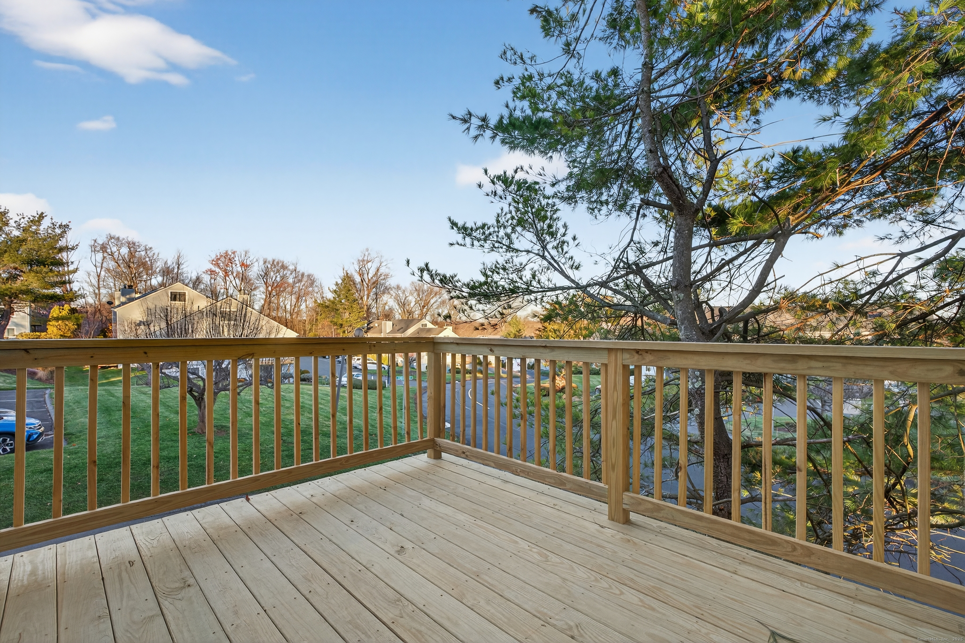 3 Sun Ridge Lane, Unit 3 Cromwell, CT 06416 - Photo 32 of 38 a view of balcony with wooden floor & fence