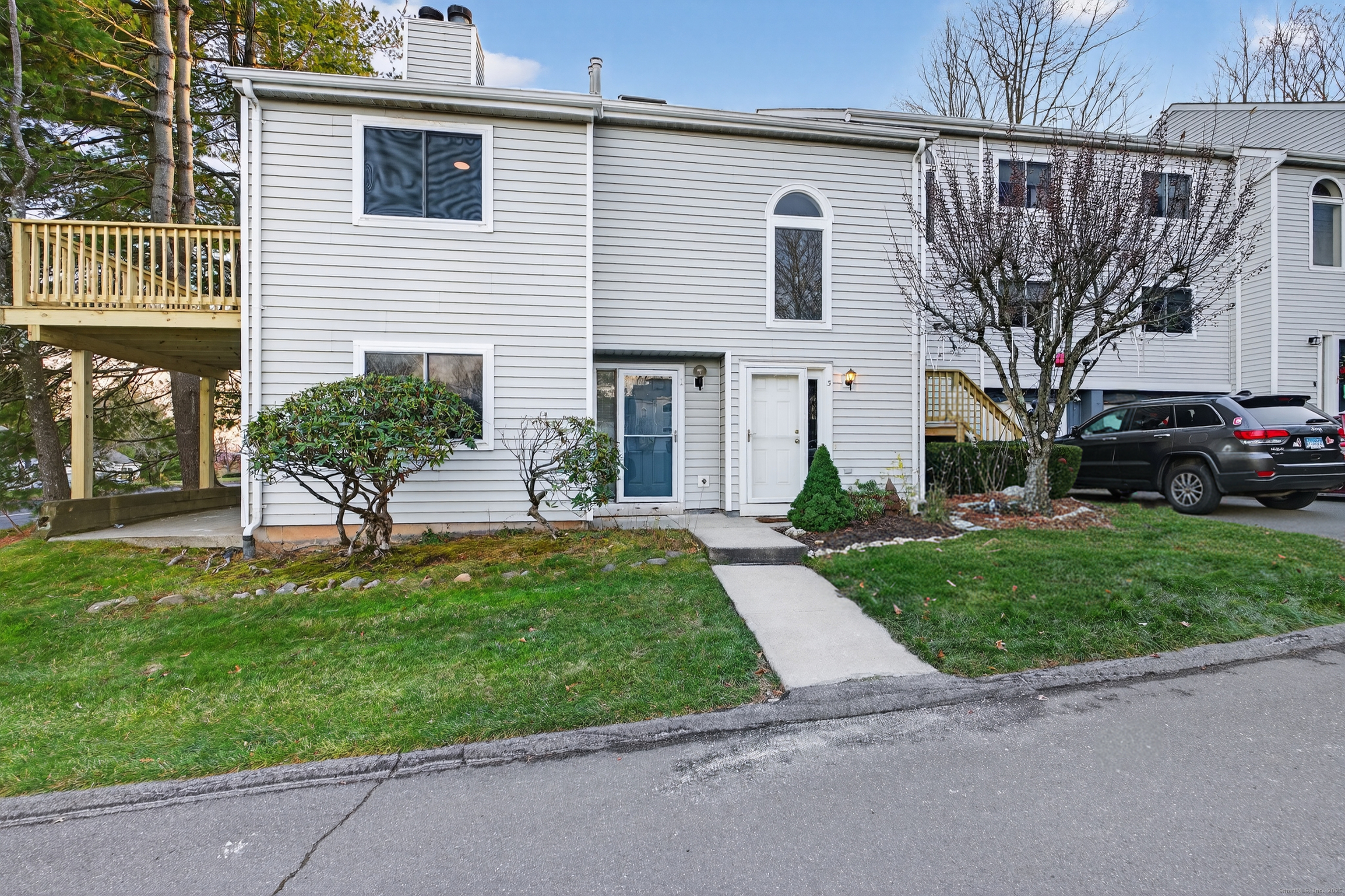 3 Sun Ridge Lane, Unit 3 Cromwell, CT 06416 - Photo 37 of 38 a front view of a house with a garden and plants