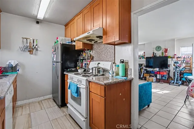 a kitchen with stainless steel appliances granite countertop a sink stove and cabinets