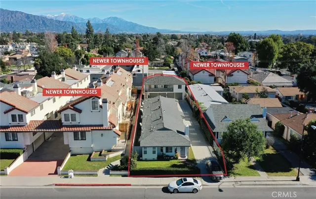 an aerial view of multiple houses with yard