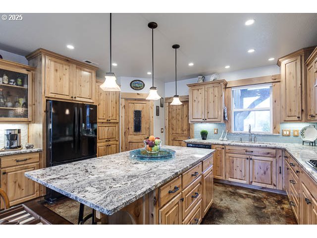 22243 Hiawatha Road Rhododendron, OR 97049 - Photo 13 of 42 a kitchen with center island and stainless steel appliances