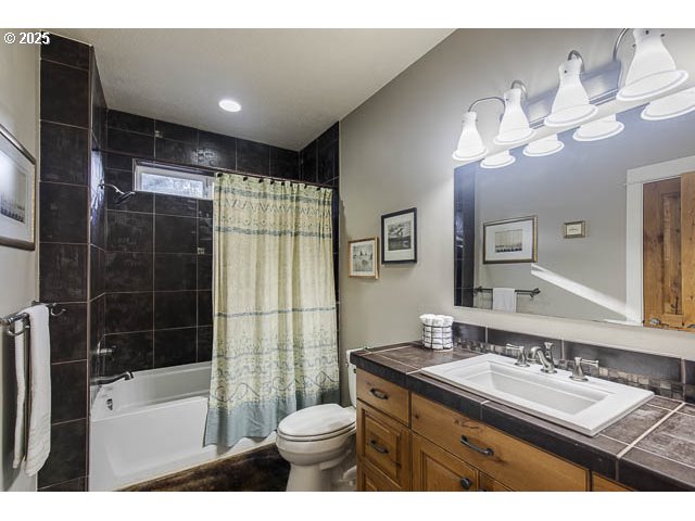 22243 Hiawatha Road Rhododendron, OR 97049 - Photo 19 of 42 a bathroom with a sink a toilet a mirror a bathtub and shower