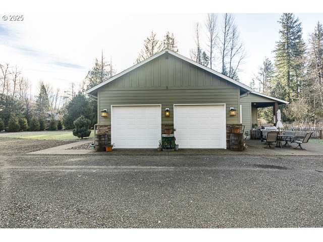 22243 Hiawatha Road Rhododendron, OR 97049 - Photo 22 of 42 a view of a house with a yard and garage