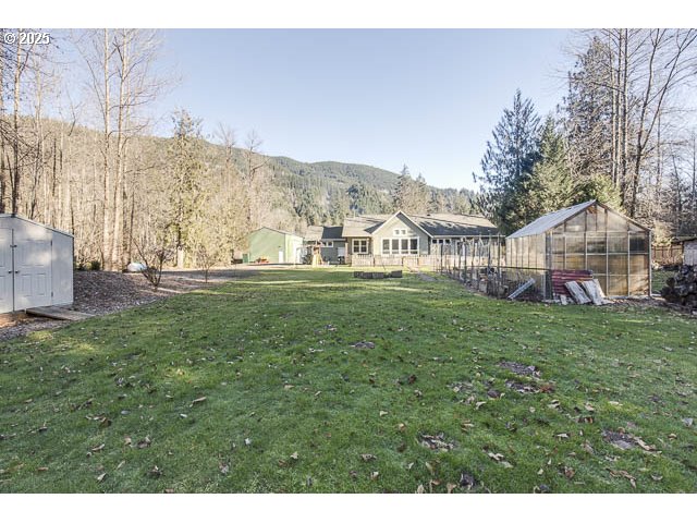 22243 Hiawatha Road Rhododendron, OR 97049 - Photo 28 of 42 a view of a house with a big yard and large trees