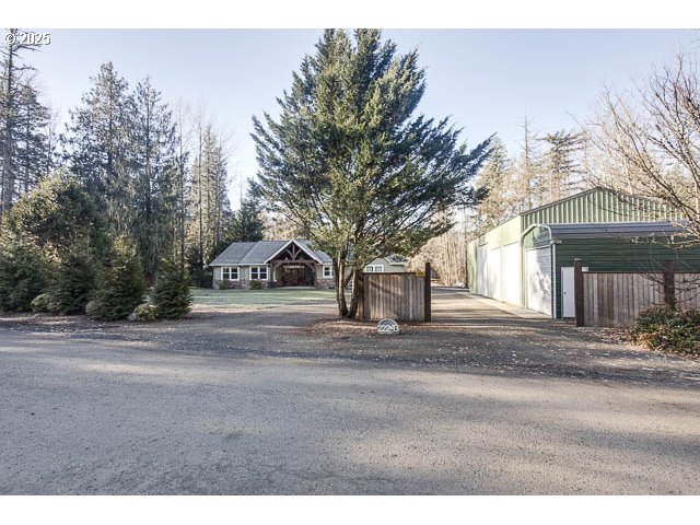 22243 Hiawatha Road Rhododendron, OR 97049 - Photo 31 of 42 a front view of a house with a yard and garage