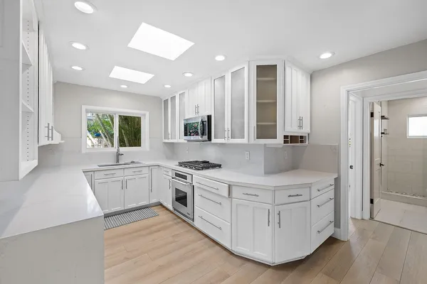 a kitchen with a sink stove and cabinets