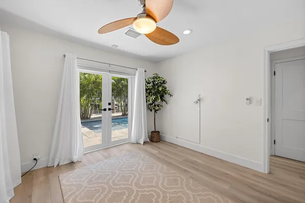 a bedroom with a large bed and a large window