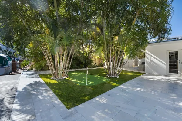 a view of a house with backyard and sitting area