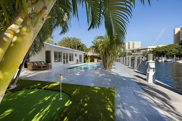 a backyard of a house with table and chairs