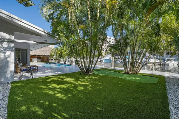 an aerial view of a house with yard swimming pool and outdoor seating