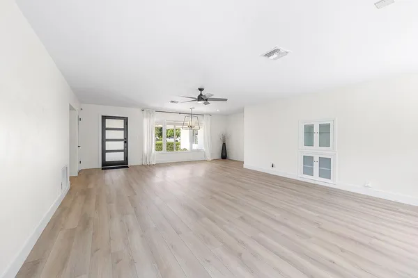 wooden floor in an empty room with a window