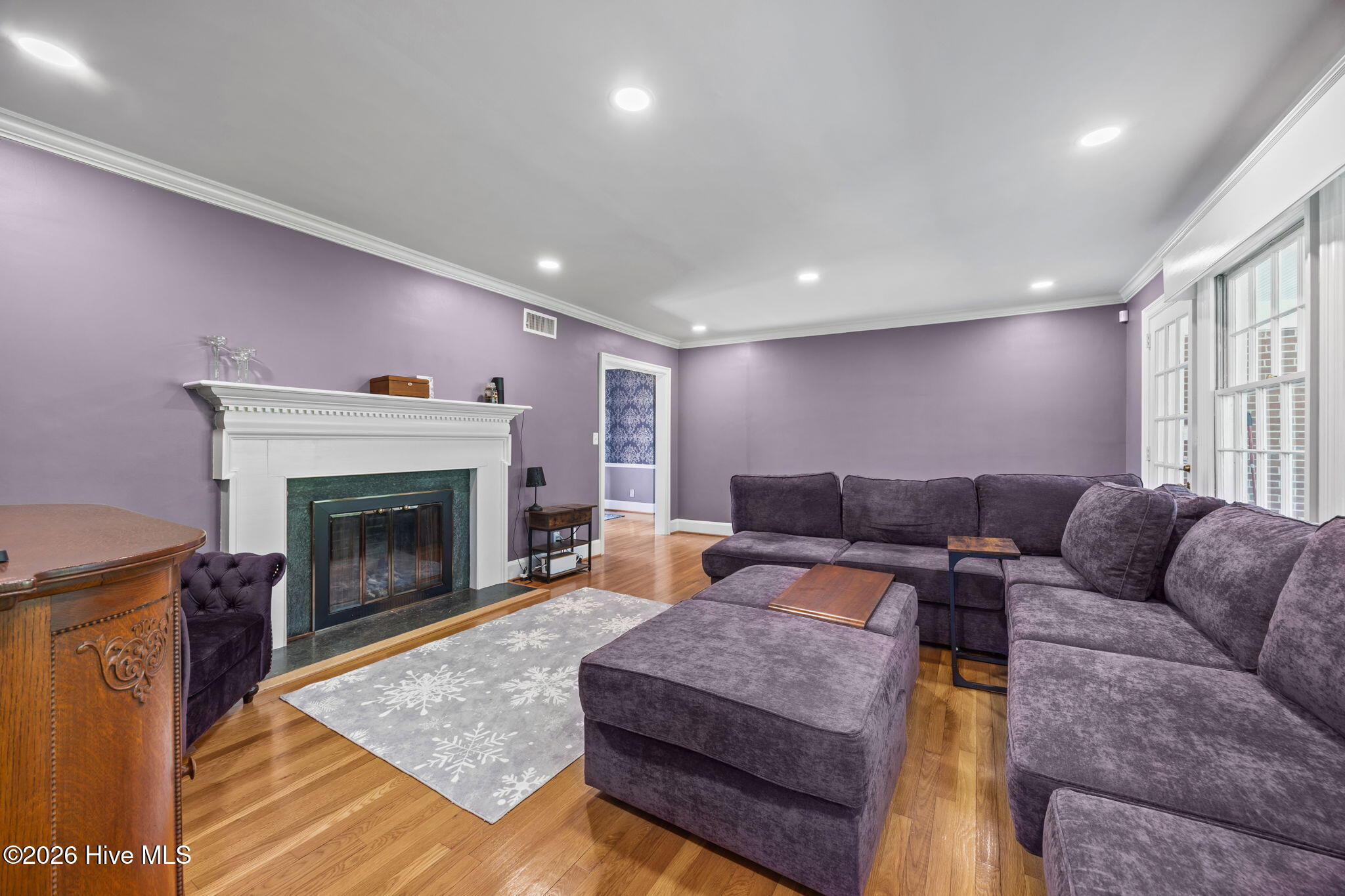 1104 West Rock Spring Road Greenville, NC 27858 - Photo 25 of 56 Moving Though Spacious Living Room - Fireplace - Wood Floors - Dining Room Behind Photographer