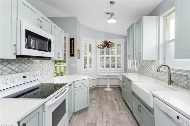 a kitchen with a sink stove and microwave