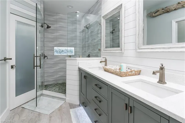 a bathroom with a shower sink and mirror