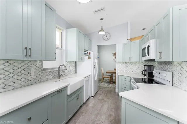 a kitchen with a sink appliances and cabinets