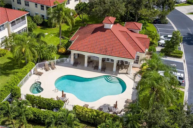an aerial view of a house with swimming pool and garden