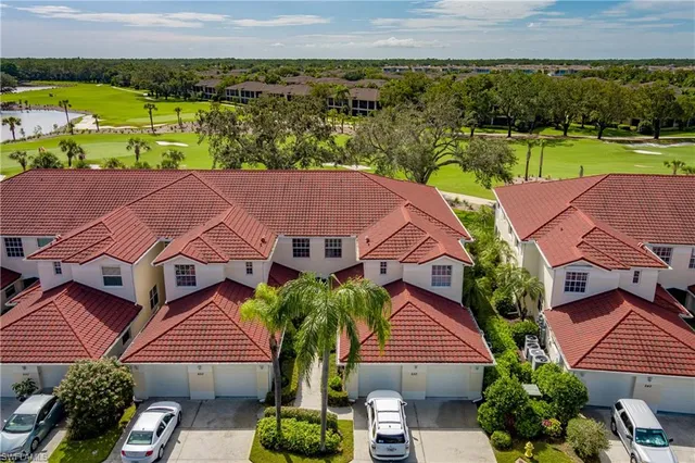 an aerial view of multiple houses with yard