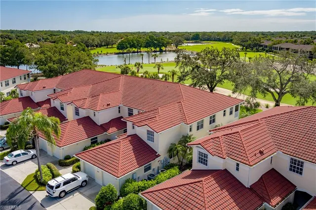 an aerial view of a house with a garden and lake view