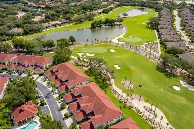 an aerial view of residential houses with outdoor space and swimming pool