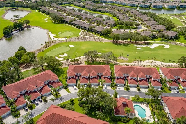 an aerial view of residential houses with outdoor space and swimming pool