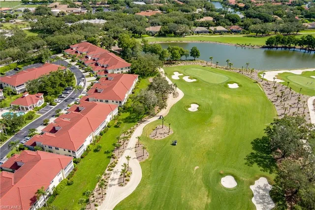 an aerial view of a house with a garden and lake view