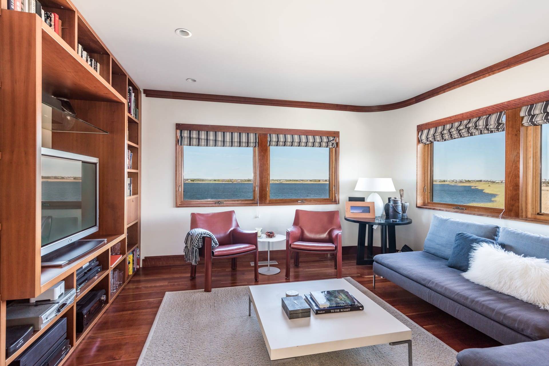 360 Dune Road Bridgehampton, NY 11932 - Photo 11 of 20 a living room with furniture wooden floor and a flat screen tv