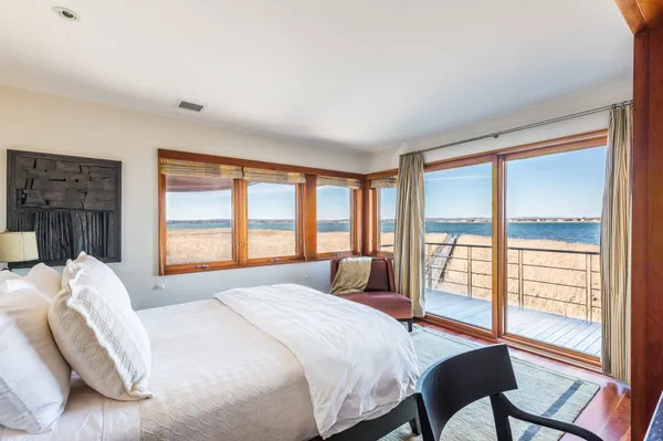 a bedroom with a bed and a large window