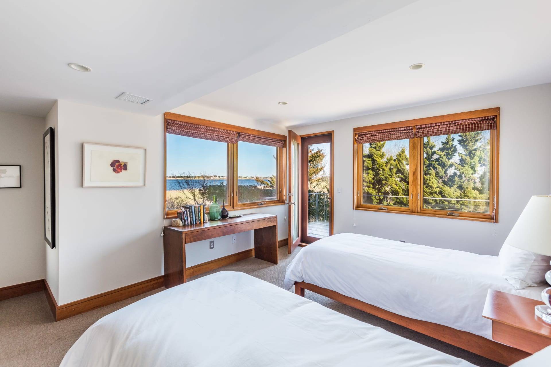 360 Dune Road Bridgehampton, NY 11932 - Photo 14 of 20 a bedroom with a large bed and a large window