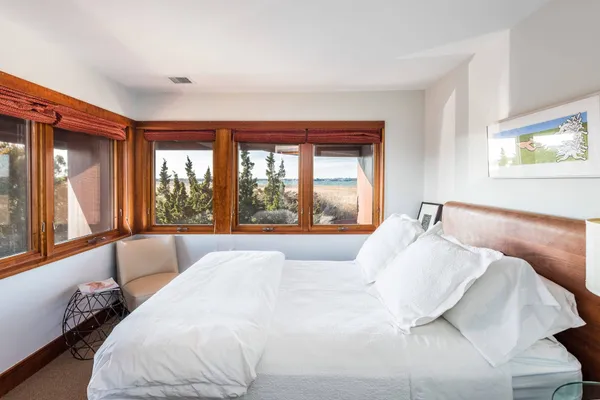 a bed sitting in a bedroom next to a window