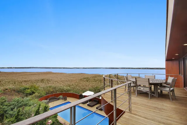 a view of a city from a balcony with seating space