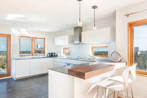 a kitchen with stainless steel appliances granite countertop a sink and a stove