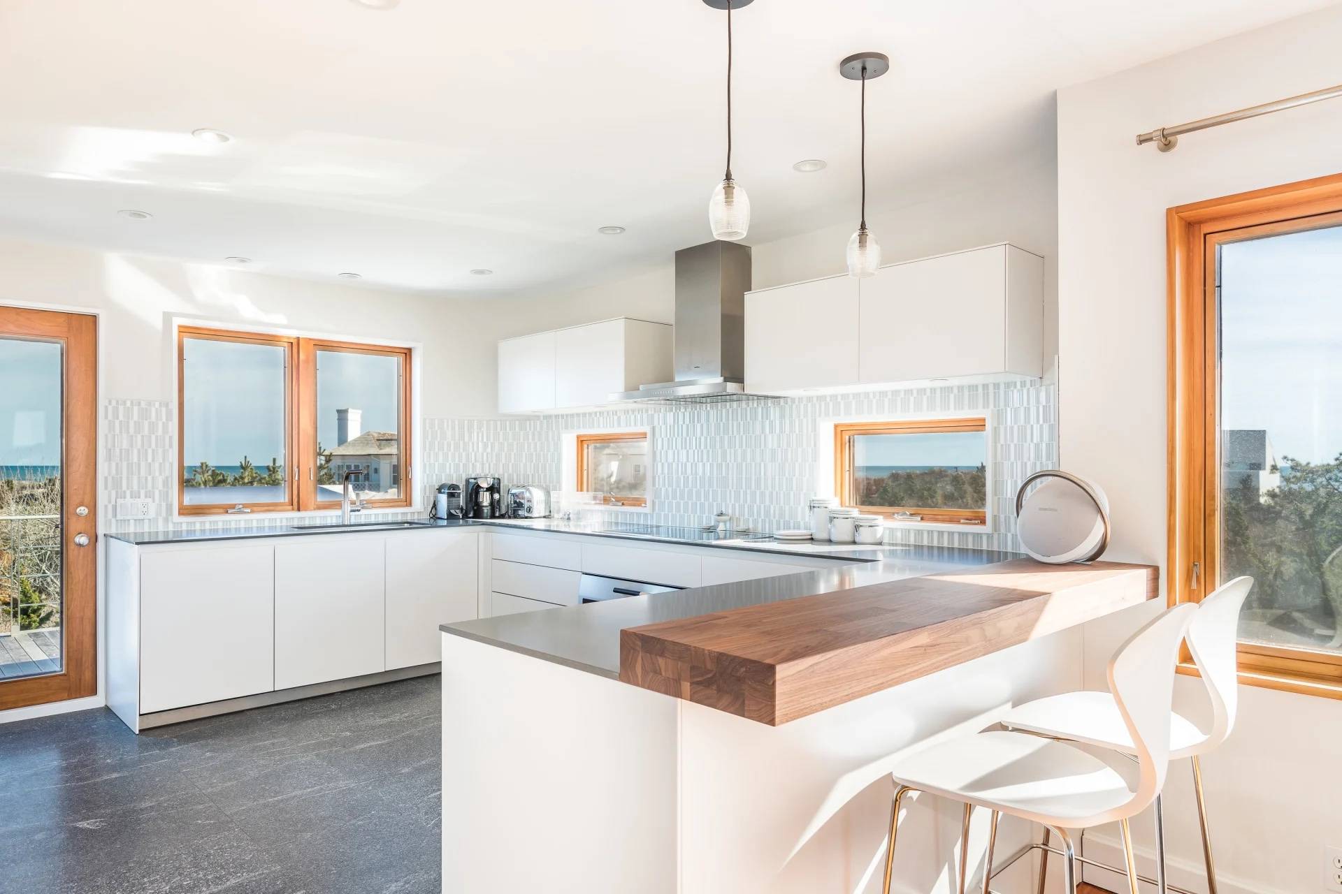 360 Dune Road Bridgehampton, NY 11932 - Photo 10 of 20 a kitchen with stainless steel appliances granite countertop a sink and a stove