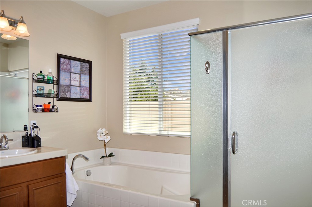 166 Fox Lane Calimesa, CA 92320 - Photo 39 of 76 Main Suite Bath with Dual Sinks, Soaking Tub, Glass-Enclosed Stall Shower, Private Toilet Room, and a Large Walk-in Closet