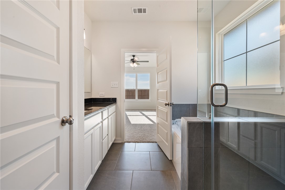 2415 Rooke Road Bryan, TX 77807 - Photo 31 of 36 a bathroom with a sink a toilet and mirror