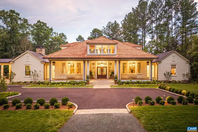 a front view of a house with a yard and outdoor seating
