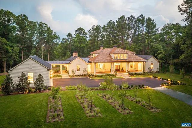 a front view of a house with yard and green space