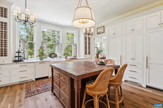 a view of a hallway with wooden floor and stairs
