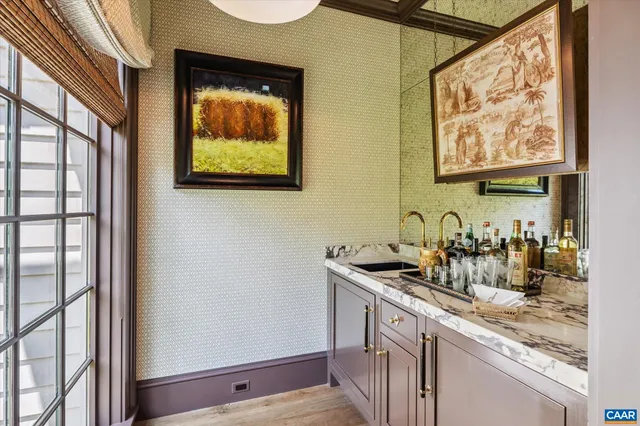 a bedroom with furniture and a large window