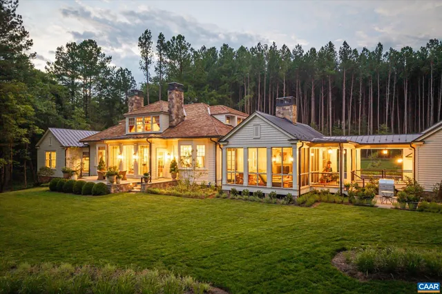 an aerial view of residential houses with outdoor space and trees
