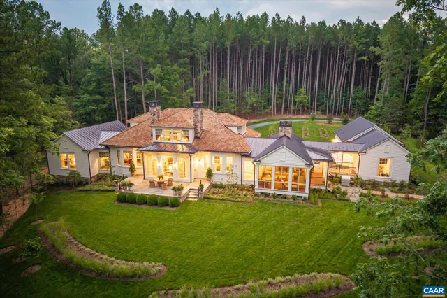 an aerial view of a house with a yard swimming pool a patio and yard