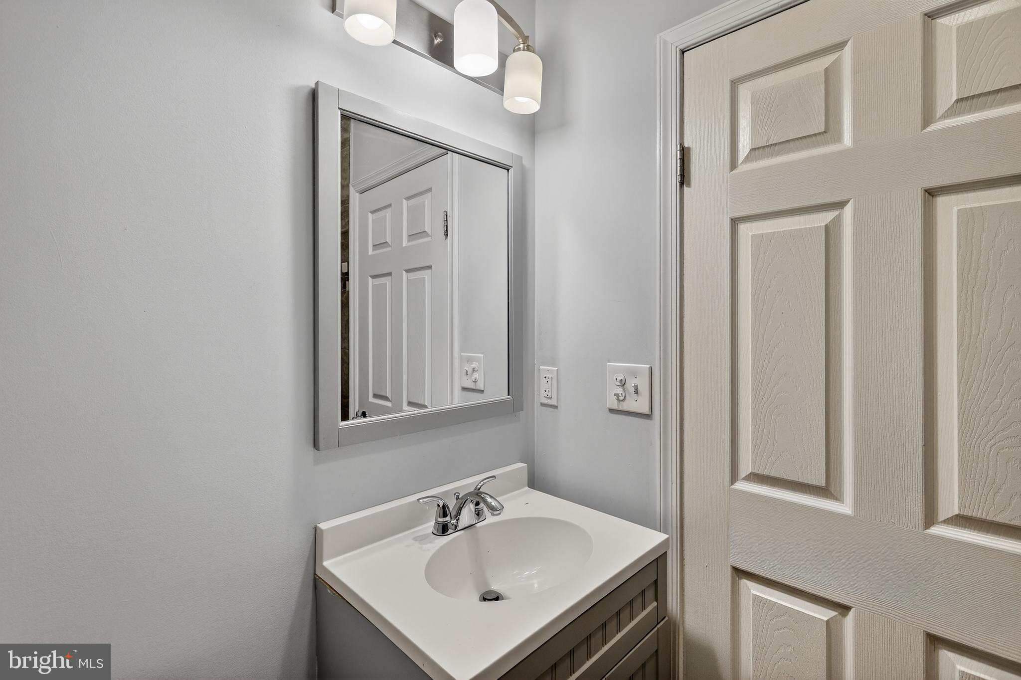 5619 1st Street Northwest, Unit 2 Washington, DC 20011 - Photo 11 of 27 a bathroom with a sink a mirror and shower